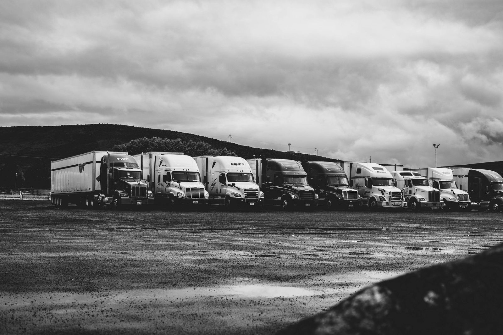 Row of semi trucks parked at a truck stop